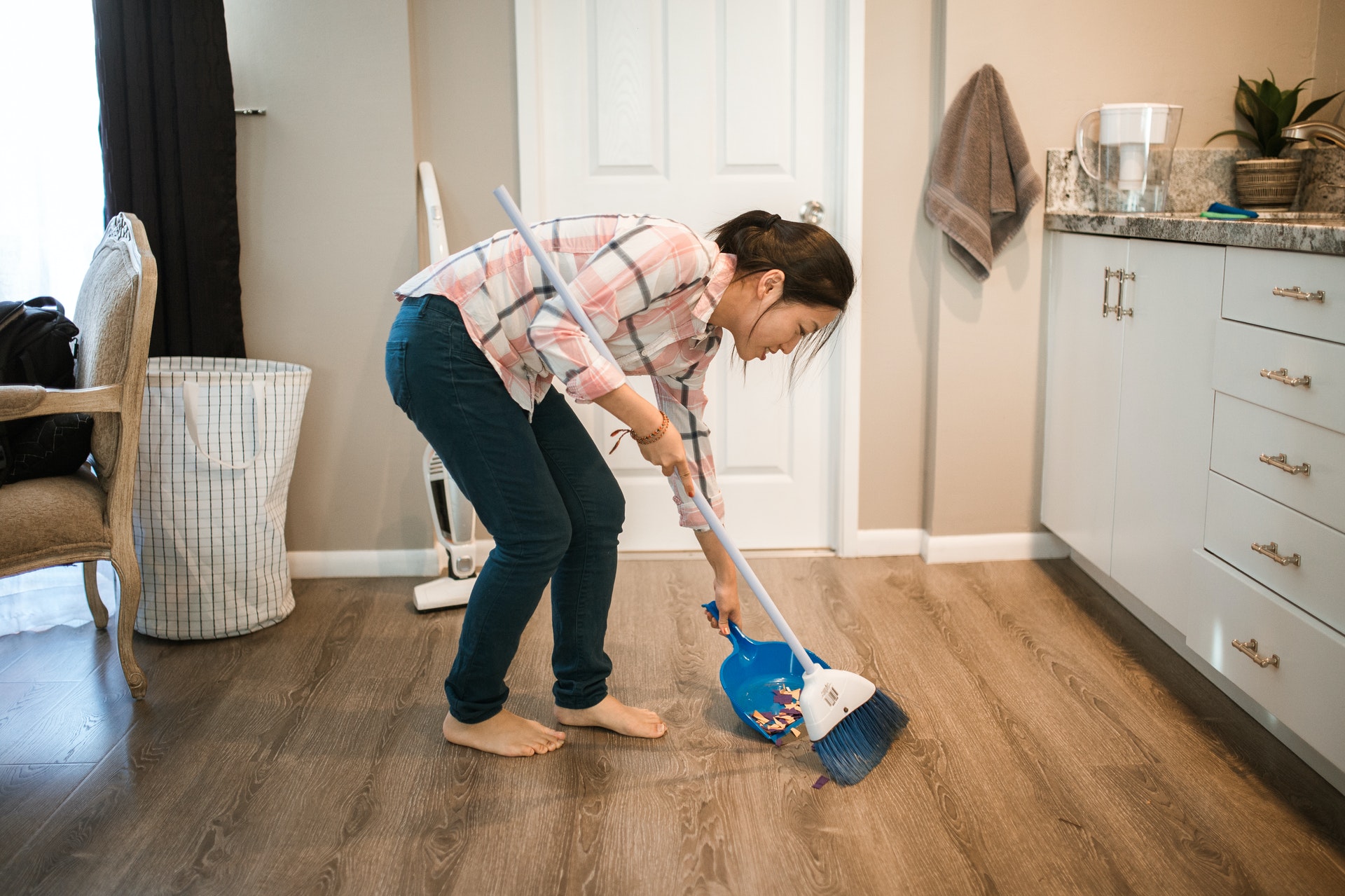 person sweeping in their luxury apartment North Dallas