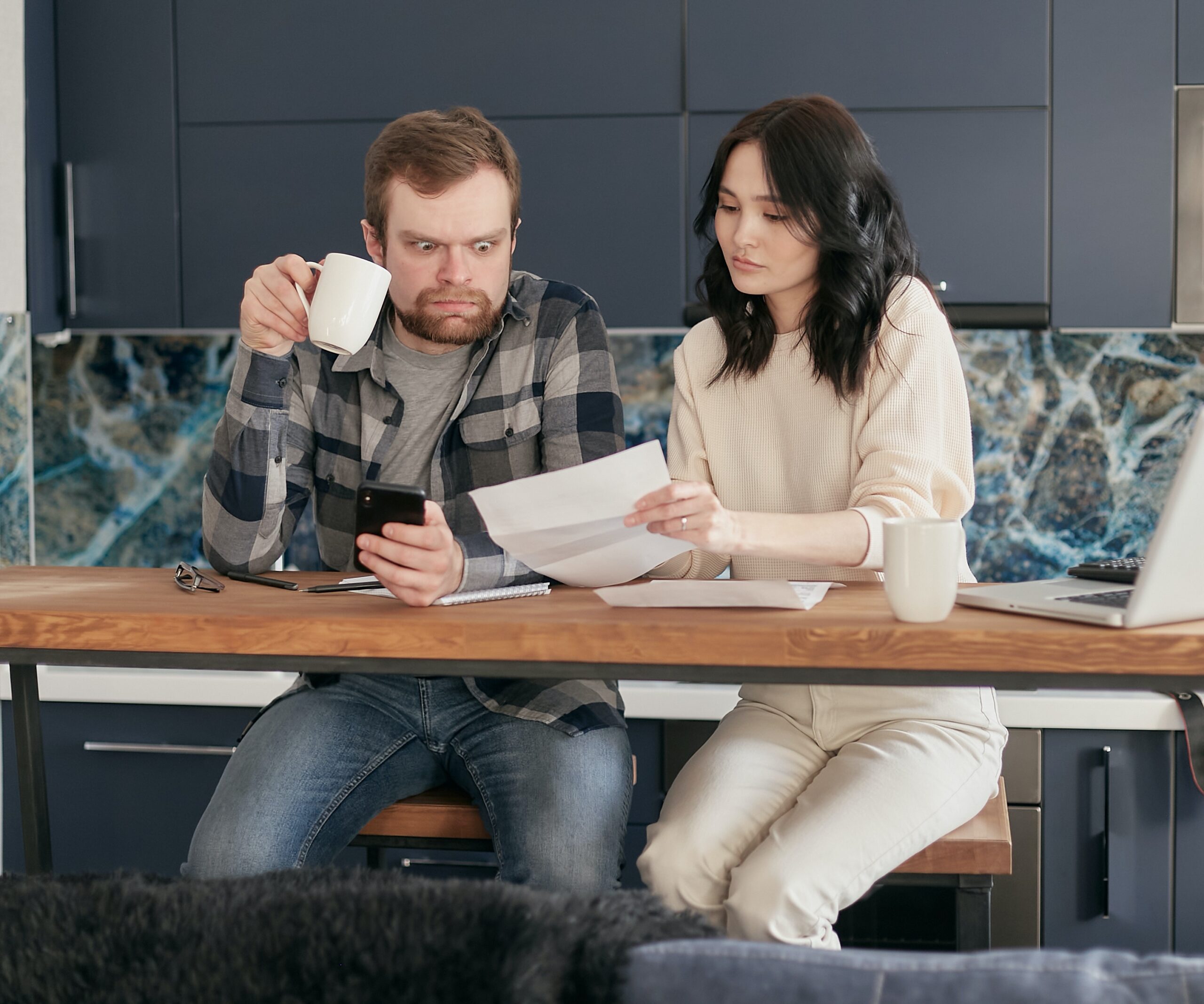 man and woman reading paper establishing credit while renting