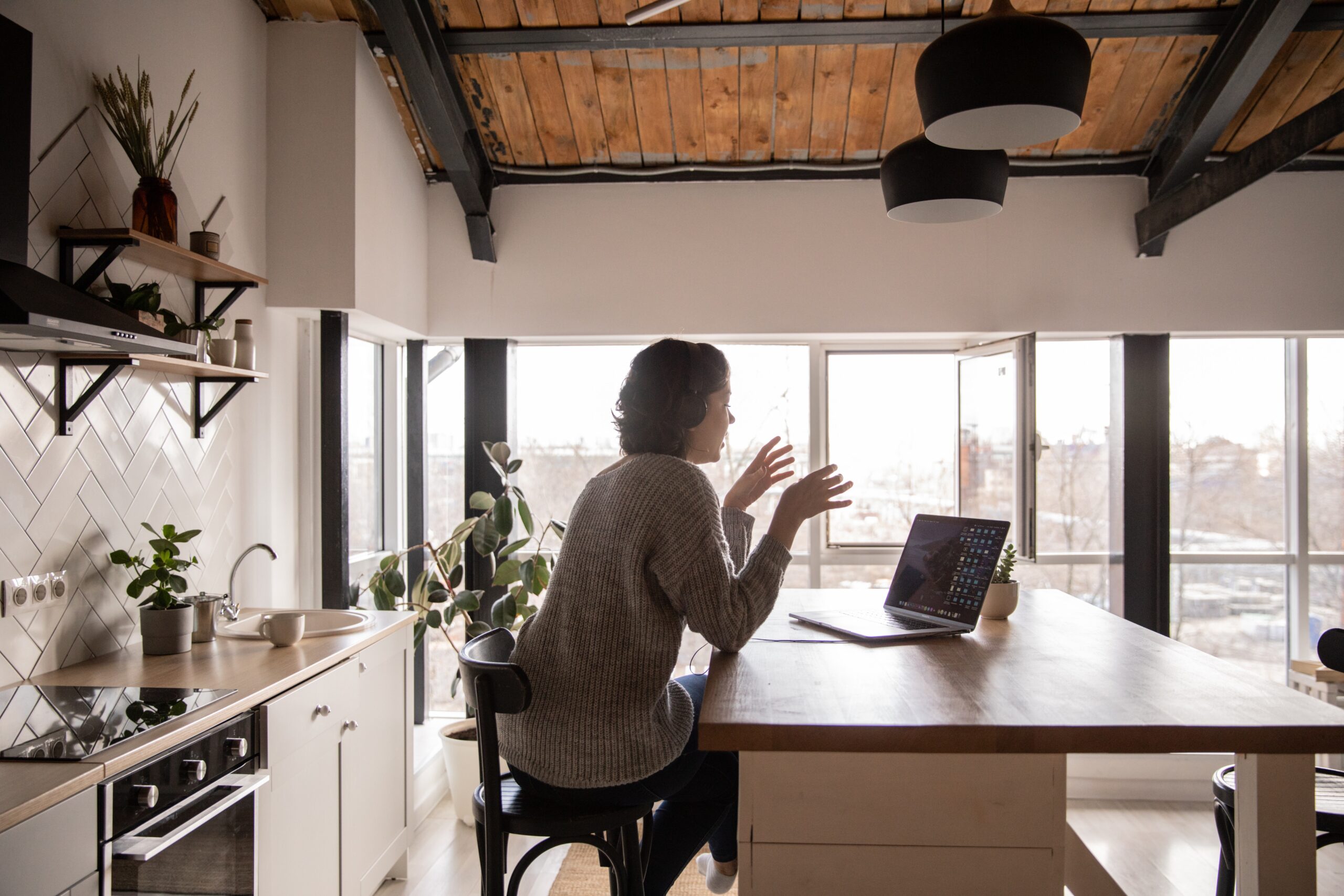 woman on laptop in modern kitchen rpm living