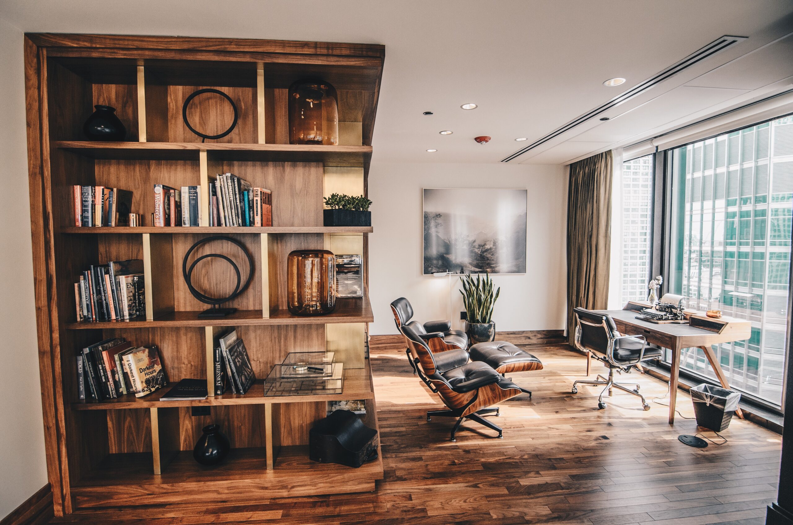 modern home office with large bookshelf and ample natural light