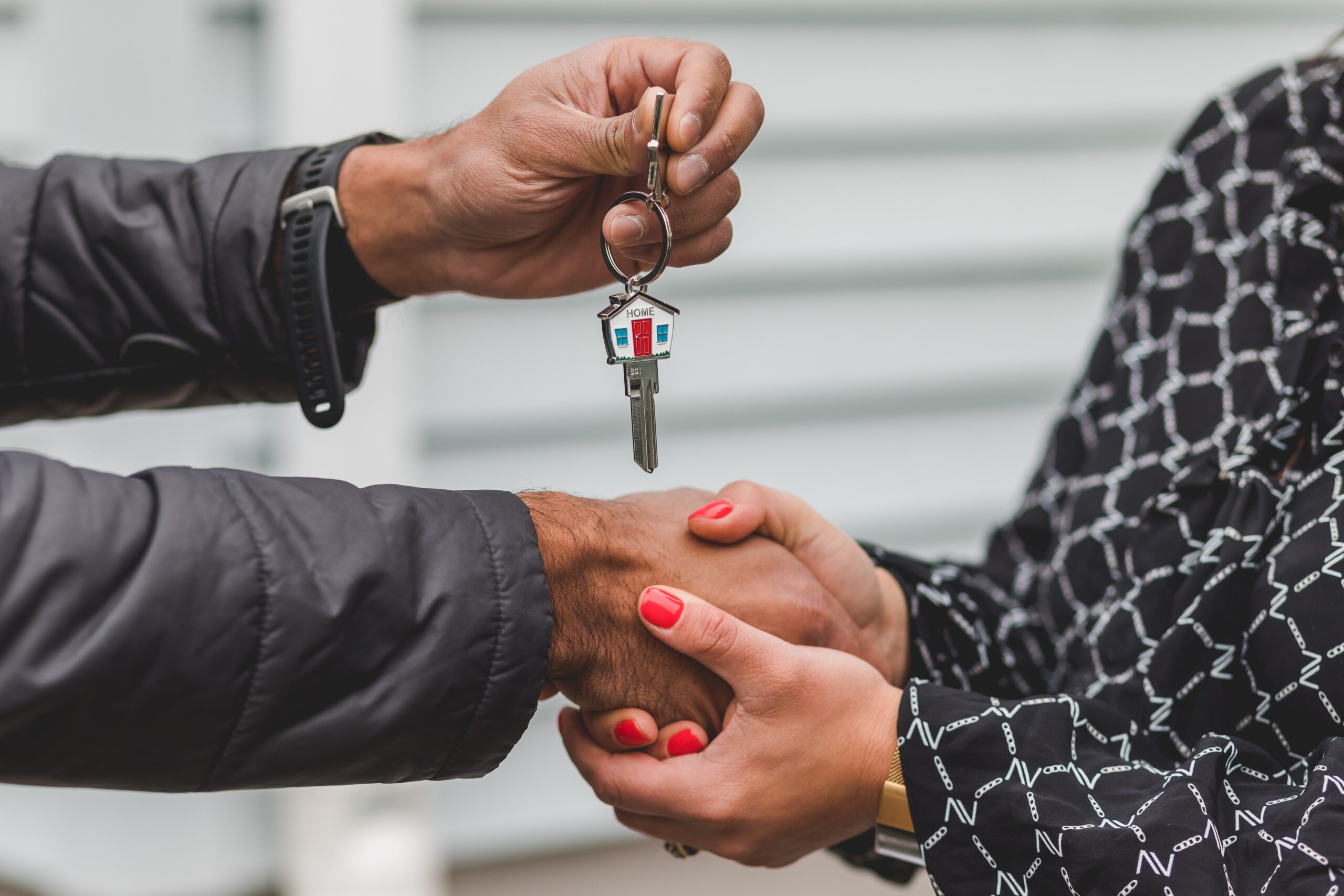 property management rpm living person handing over house key to new resident