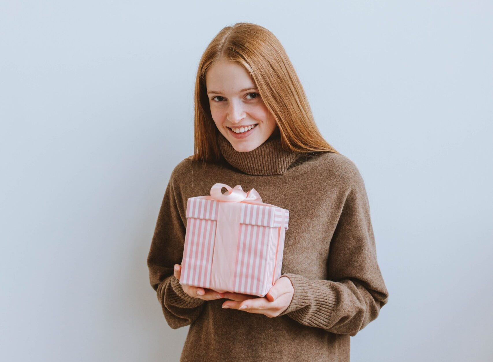 redheaded girl holding white and red present rpm living blog last minute holiday gift ideas