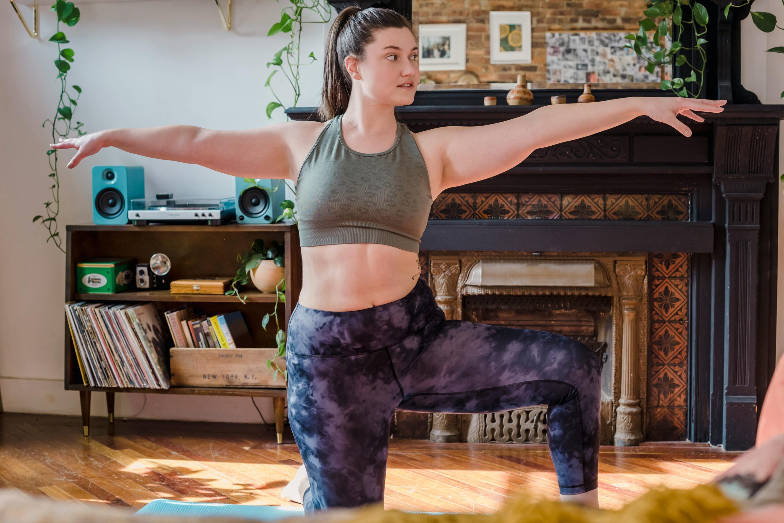 apartment-friendly home workout gear woman doing yoga at home rpm living blog