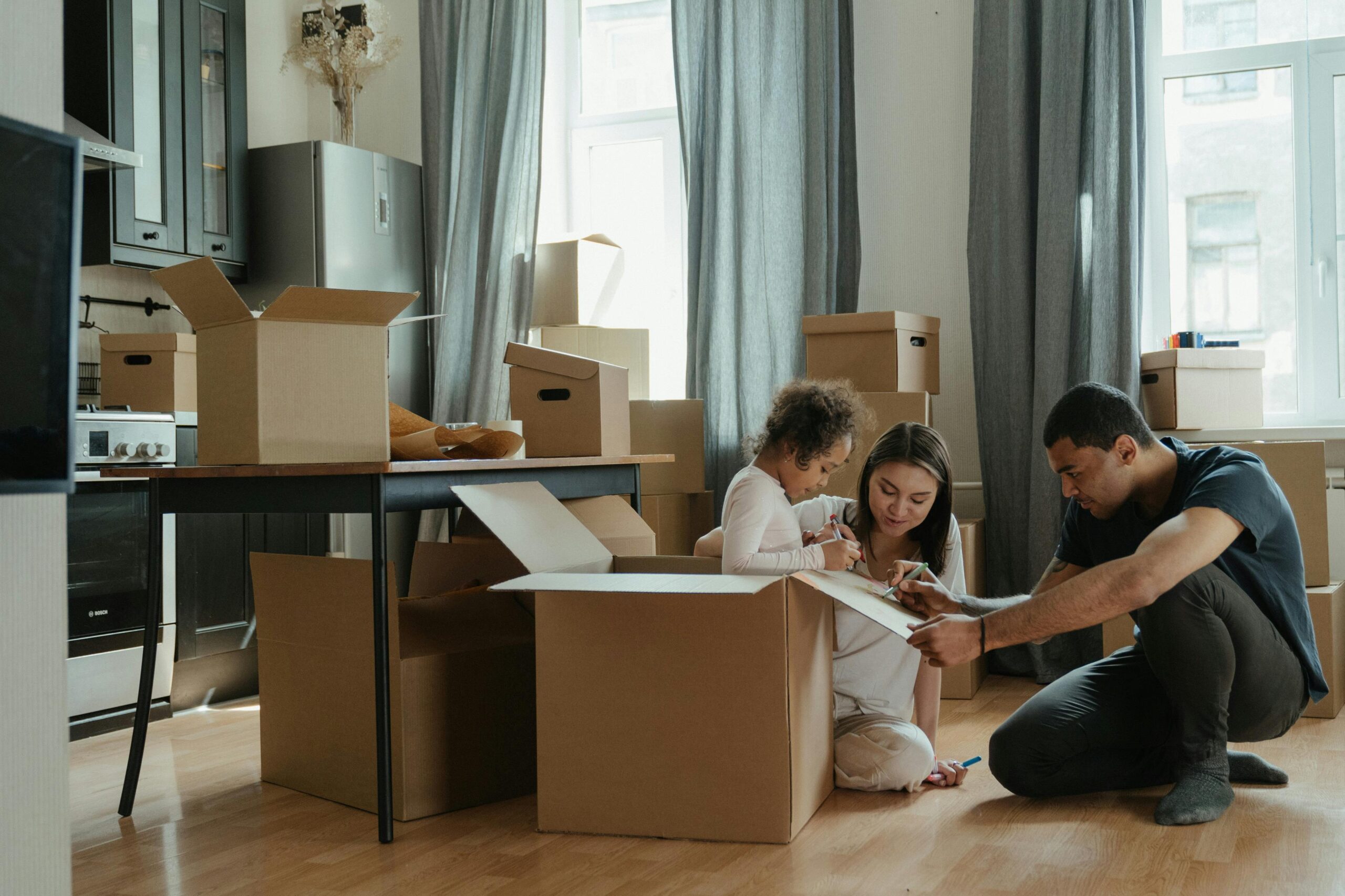 family in apartment with moving boxes 5 Signs It’s Time to Upgrade Your Apartment to RPM Living